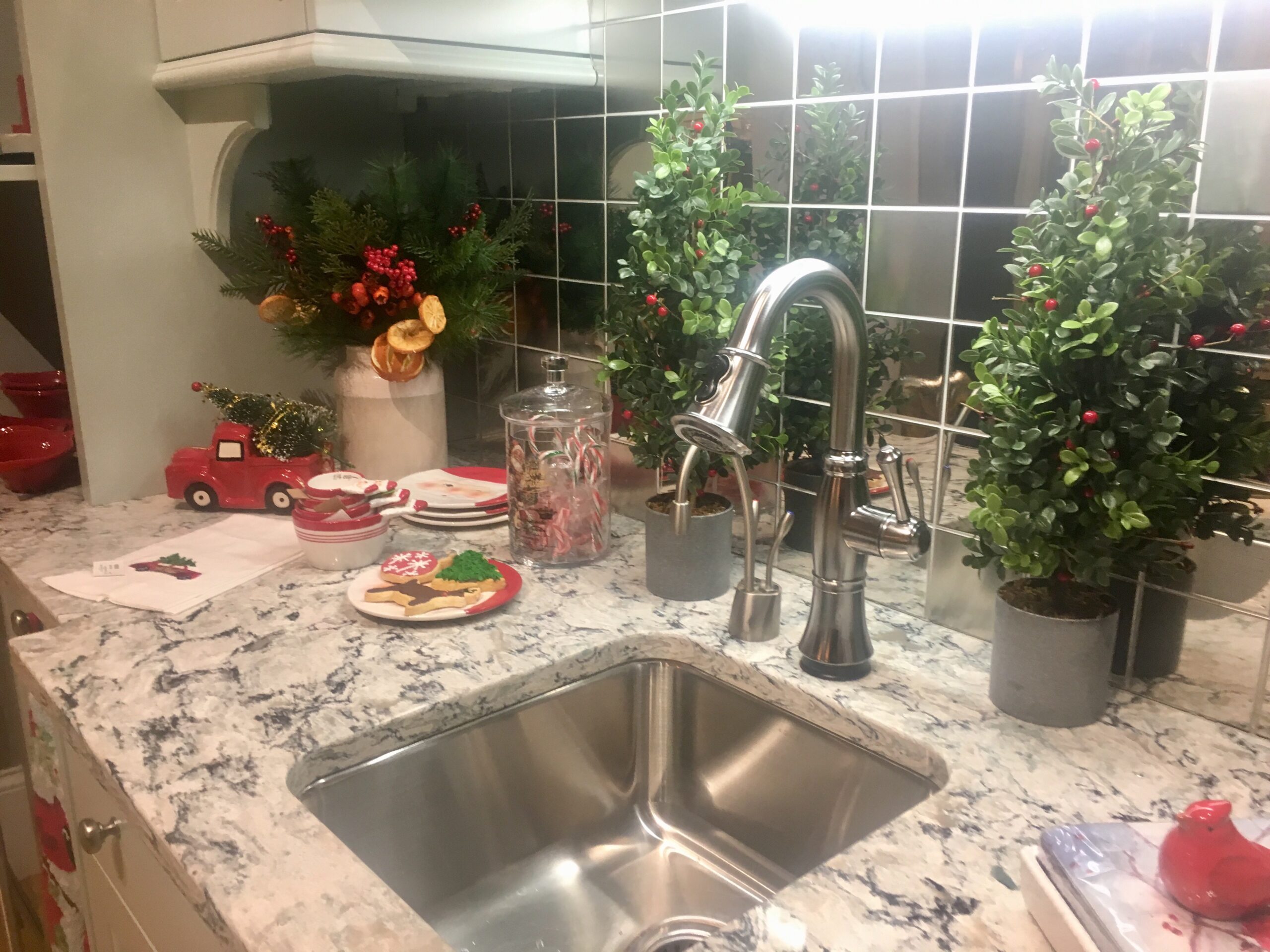 Kitchen sink countertop tiled backsplash decorated for the Christmas holidays